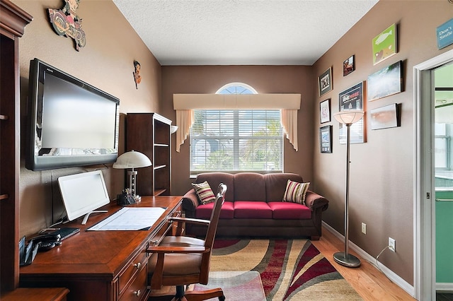 office area featuring hardwood / wood-style floors and a textured ceiling