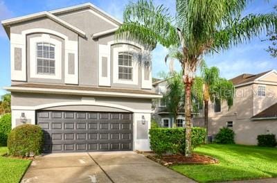 view of front facade with a garage and a front yard