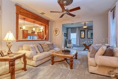 living room with carpet and ceiling fan