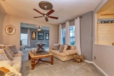 living room featuring ceiling fan and carpet floors