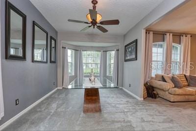 interior space with ceiling fan and a wealth of natural light