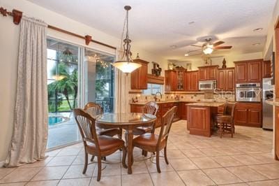 tiled dining area featuring ceiling fan and a wealth of natural light