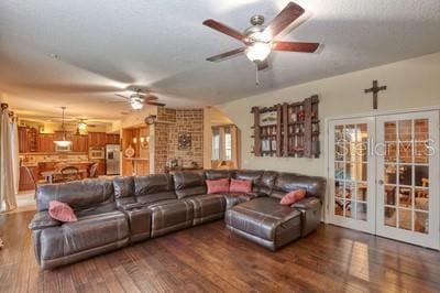 living room featuring ceiling fan, french doors, and dark wood-type flooring