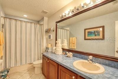 bathroom featuring toilet, a textured ceiling, tile patterned floors, a shower with shower curtain, and vanity