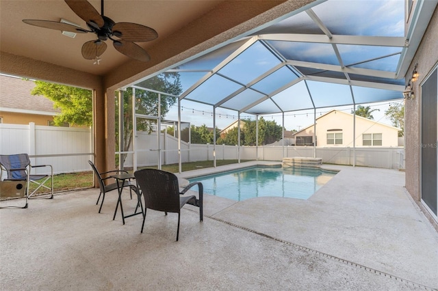 view of swimming pool with ceiling fan, a patio, and a lanai