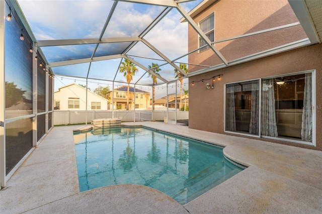 view of pool featuring a patio and glass enclosure