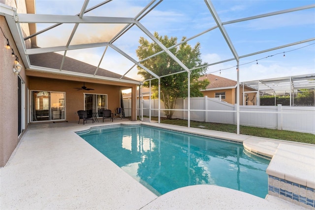 view of pool with a patio, ceiling fan, and a lanai