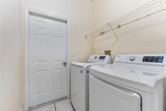 laundry area featuring independent washer and dryer and light tile patterned floors