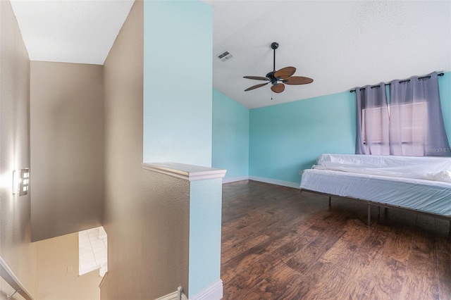 bedroom with dark wood-type flooring, ceiling fan, and vaulted ceiling