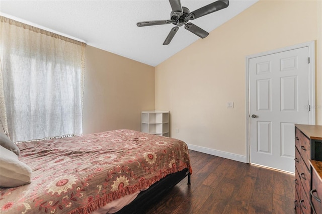 bedroom with lofted ceiling, dark hardwood / wood-style floors, and ceiling fan