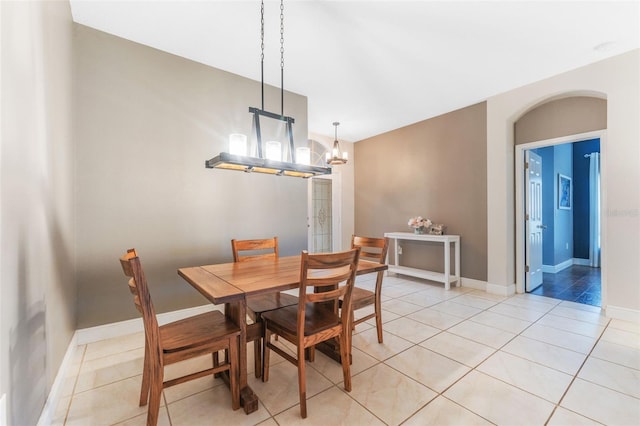 tiled dining area with a notable chandelier