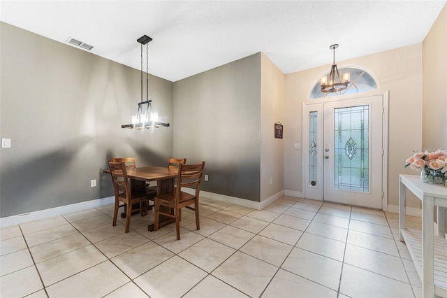 foyer entrance featuring an inviting chandelier and light tile patterned flooring