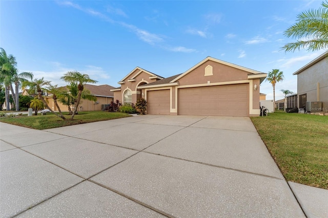 single story home featuring central air condition unit, a front lawn, and a garage