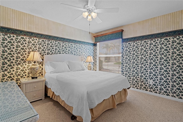 carpeted bedroom with a textured ceiling and ceiling fan