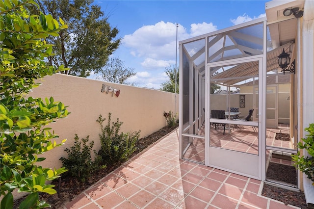 view of patio / terrace with a lanai