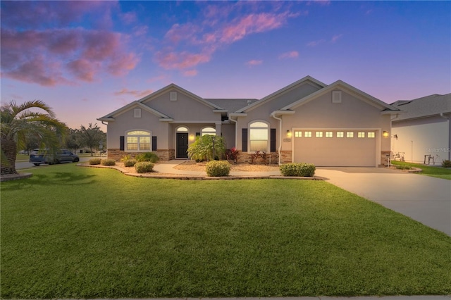 view of front facade with a yard and a garage