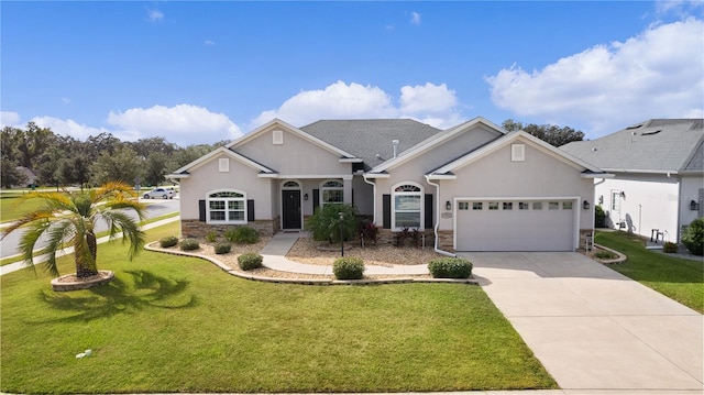 9702 Pepper Tree Pl, Wildwood, FL 34785 - view of front facade with driveway, a front lawn, an attached garage, stone siding, and stucco siding