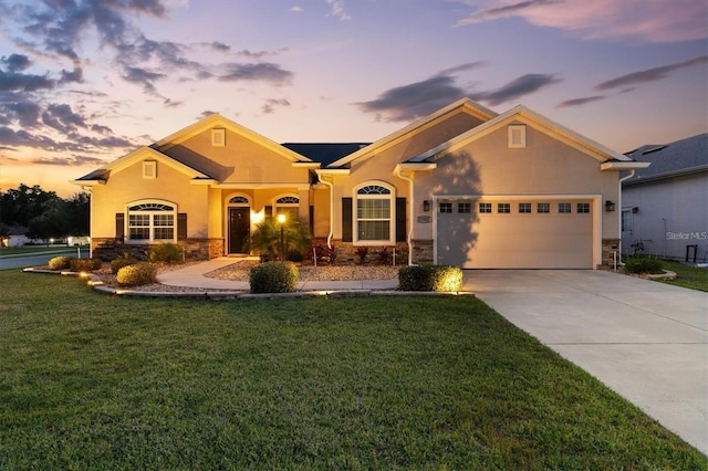 9702 Pepper Tree Pl, Wildwood, FL 34785 - view of front of property featuring a front lawn, stone siding, stucco siding, concrete driveway, and an attached garage