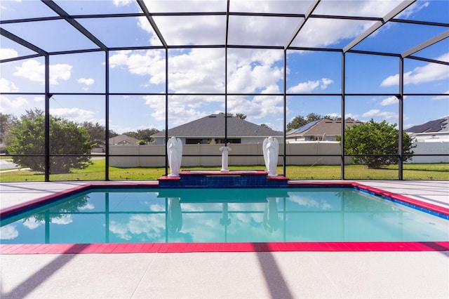 view of pool with a patio area, a lanai, and a yard