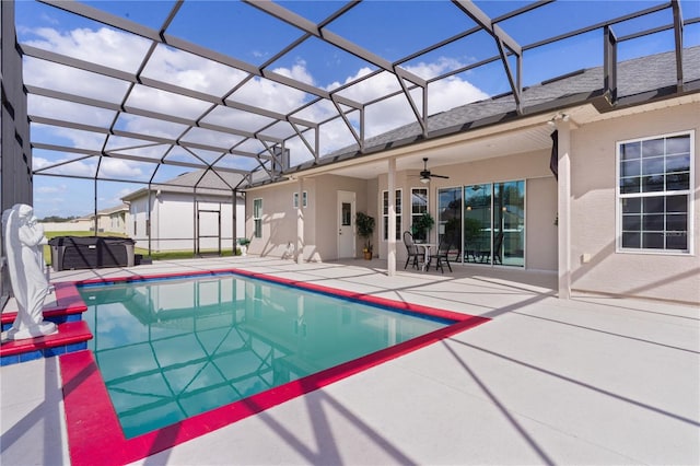 view of swimming pool with a patio, a lanai, and ceiling fan