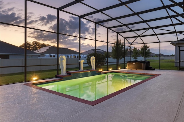 pool at dusk featuring a patio area and a lanai