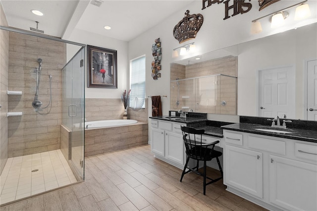 bathroom with vanity, separate shower and tub, and hardwood / wood-style floors