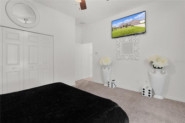 bedroom featuring light carpet, a closet, and ceiling fan