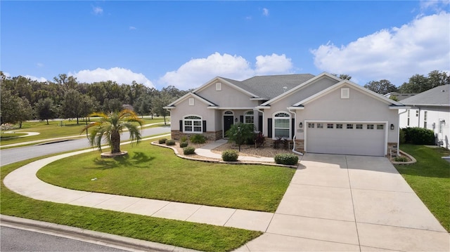 9702 Pepper Tree Pl, Wildwood, FL 34785 - view of front of property featuring an attached garage, a front yard, driveway, and stone siding