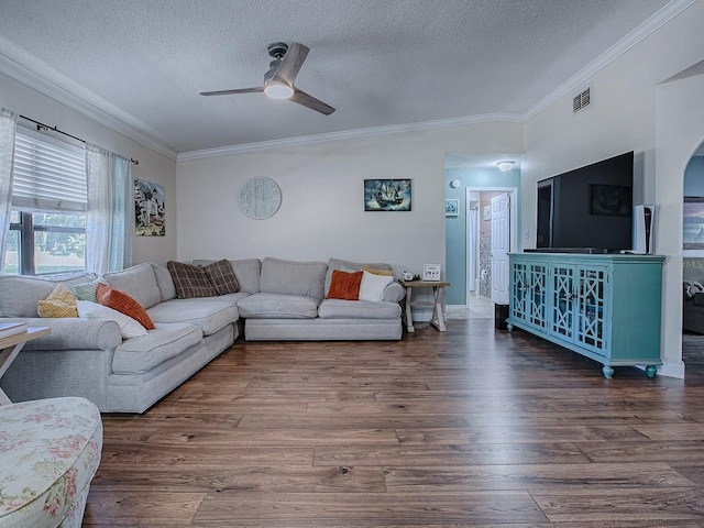 living room featuring dark wood-type flooring, ceiling fan, and a textured ceiling