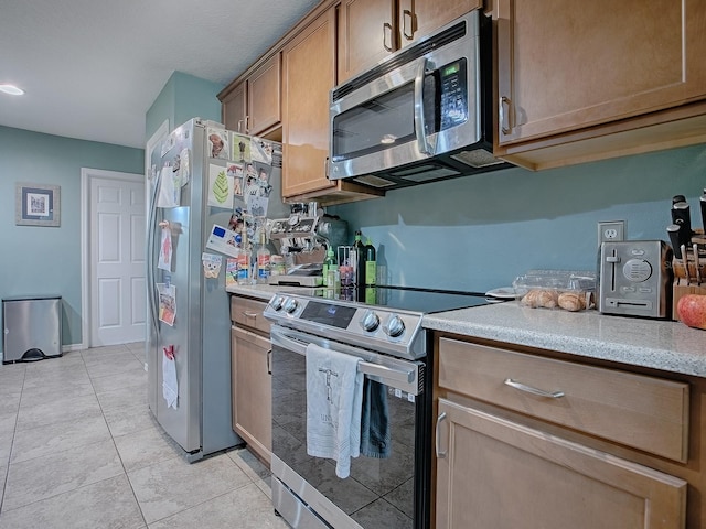 kitchen with stainless steel appliances and light tile patterned floors