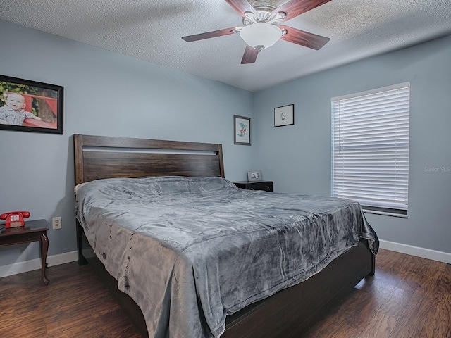 bedroom featuring ceiling fan, a textured ceiling, and dark hardwood / wood-style floors