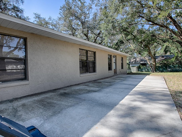 view of property exterior with a patio