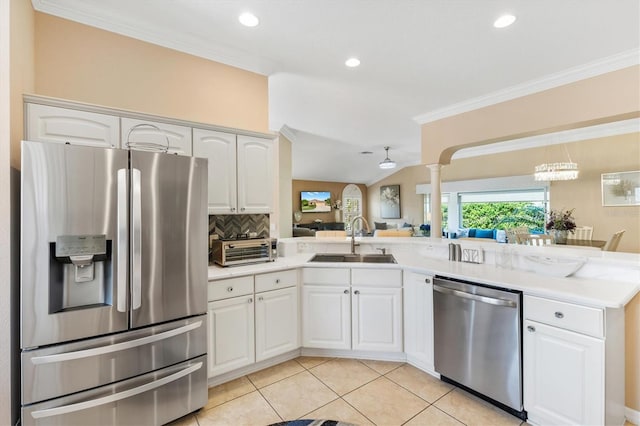 kitchen featuring white cabinetry, ornate columns, sink, tasteful backsplash, and stainless steel appliances