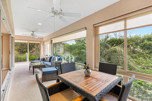 sunroom / solarium with a wealth of natural light and ceiling fan