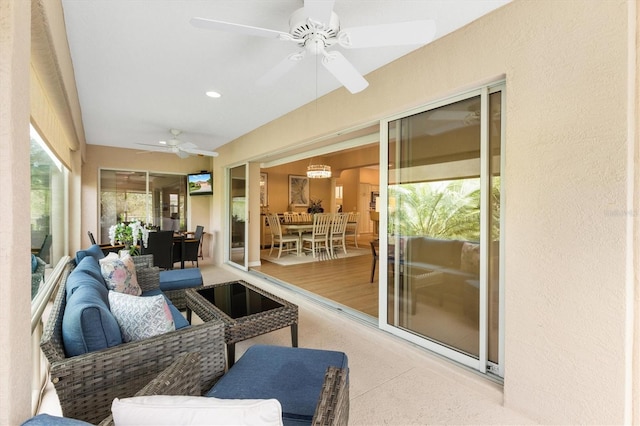 sunroom featuring ceiling fan