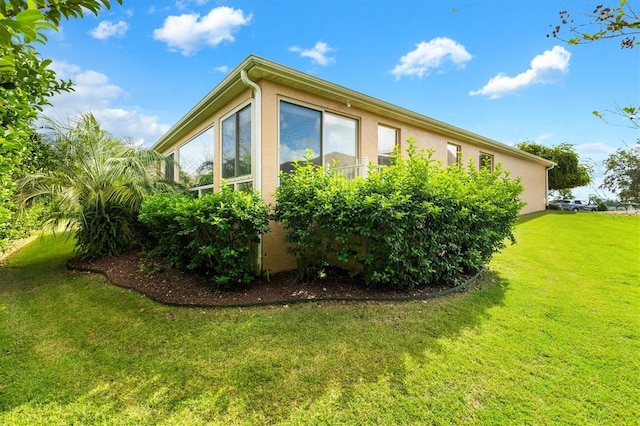 view of side of home featuring a lawn