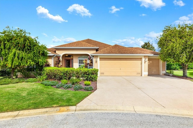 view of front of house with a front yard and a garage