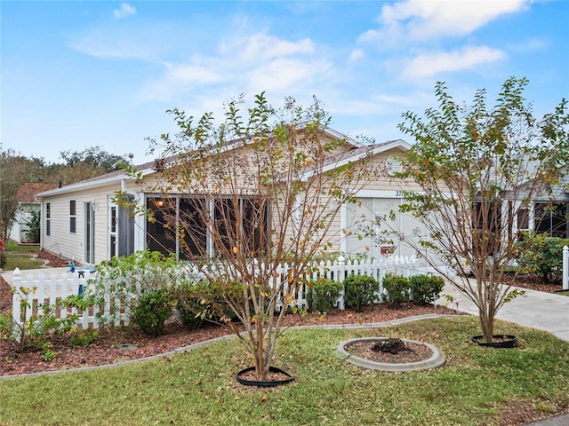 view of front of property with a garage and a front lawn