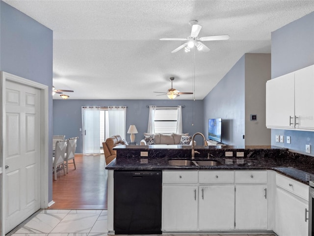 kitchen with dark stone counters, a textured ceiling, sink, dishwasher, and white cabinetry