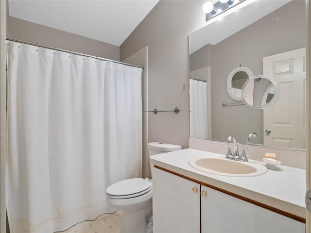 bathroom with vanity, a textured ceiling, and toilet