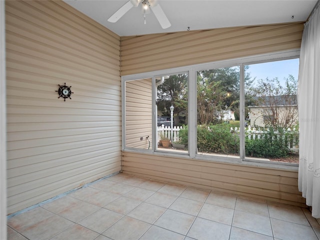 unfurnished sunroom featuring vaulted ceiling and ceiling fan