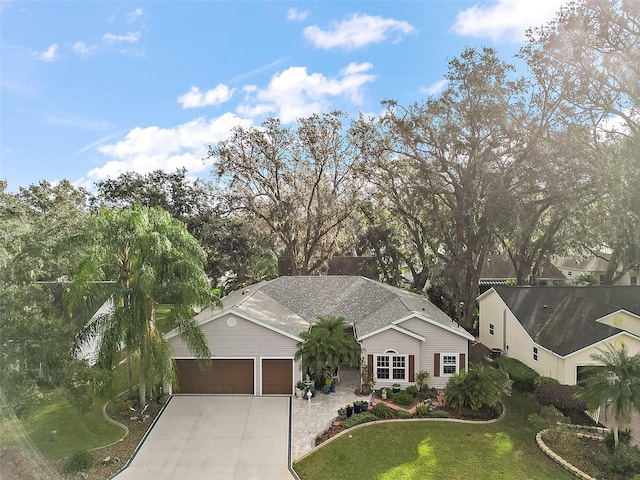 ranch-style home with a front yard and a garage