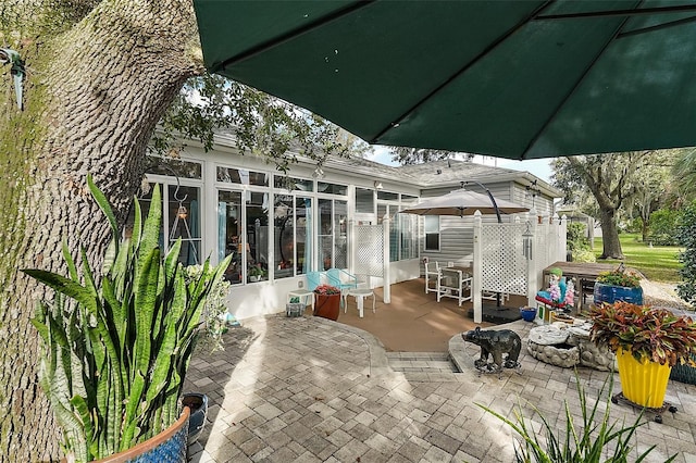 view of patio / terrace featuring a sunroom