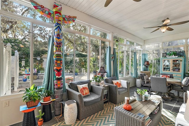 sunroom / solarium featuring ceiling fan