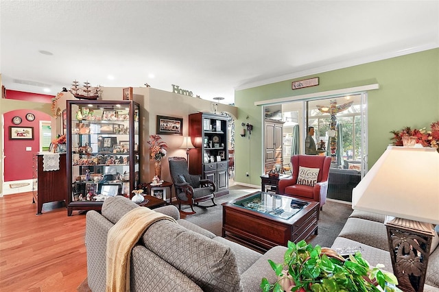 living room with hardwood / wood-style flooring and crown molding