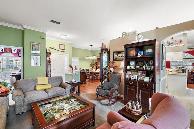 living room featuring ornamental molding and hardwood / wood-style flooring