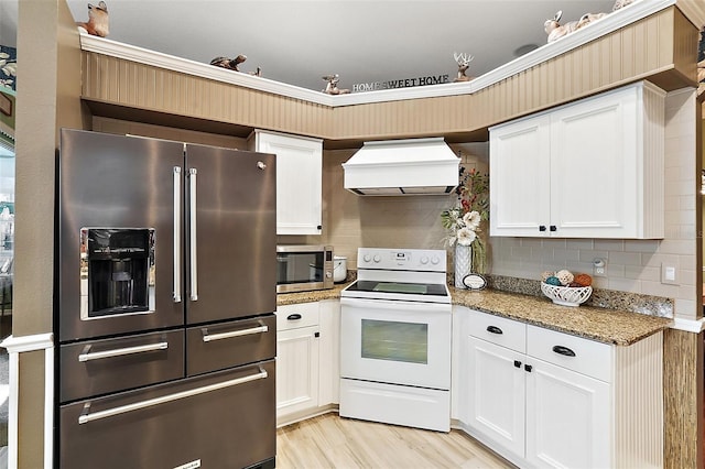 3721 Plantation Blvd, Leesburg, FL 34748 - kitchen featuring stainless steel appliances, white cabinetry, light stone countertops, decorative backsplash, and custom range hood