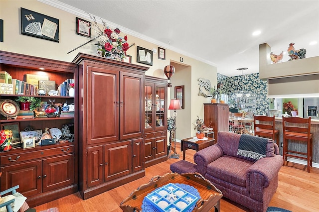 living room featuring light wood-type flooring and crown molding