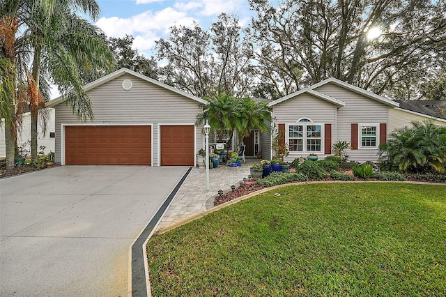 single story home featuring a garage and a front lawn