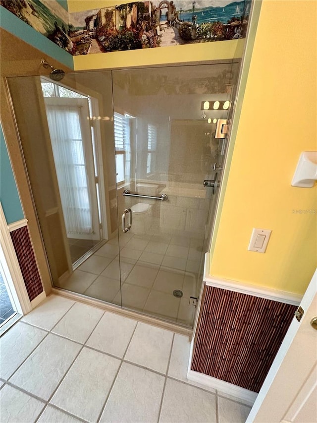 bathroom featuring a shower with shower door and tile patterned floors